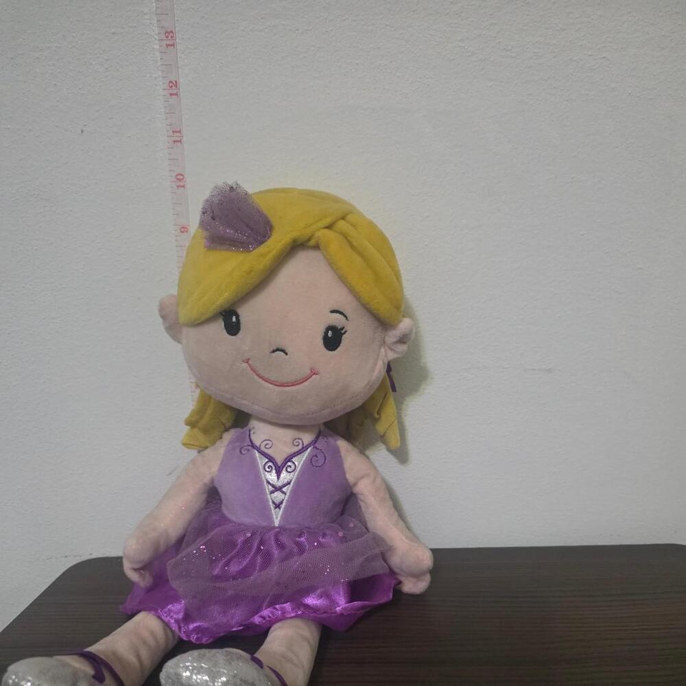 Purple & yellow doll with purple dress and glittery details #disney #princess